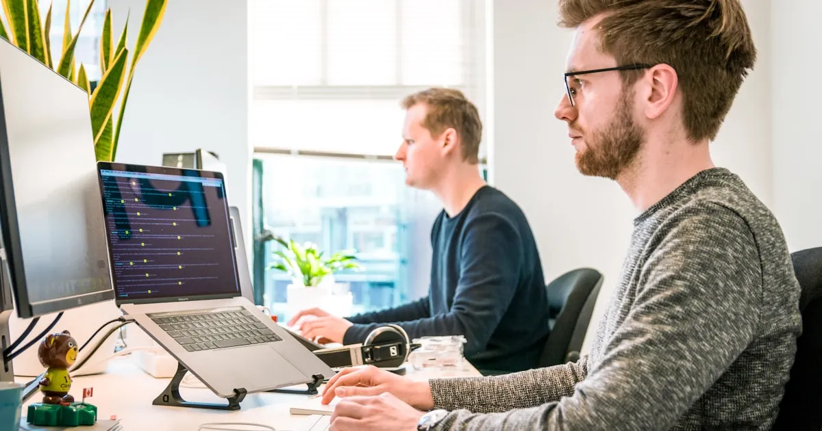 Ontwikkelaars of consultants die samen naar code op schermen kijken